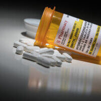 Hydrocodone Pills and Prescription Bottle with Non Proprietary Label. No model release required - contains ficticious information.